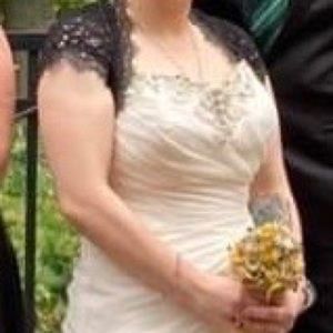 Designer wedding gown with embellished top and side.